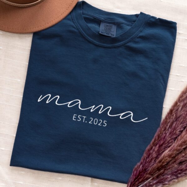 Comfort Colors Embroidered Mama T-Shirt in navy blue folded with white 'mama EST. 2025' embroidery.