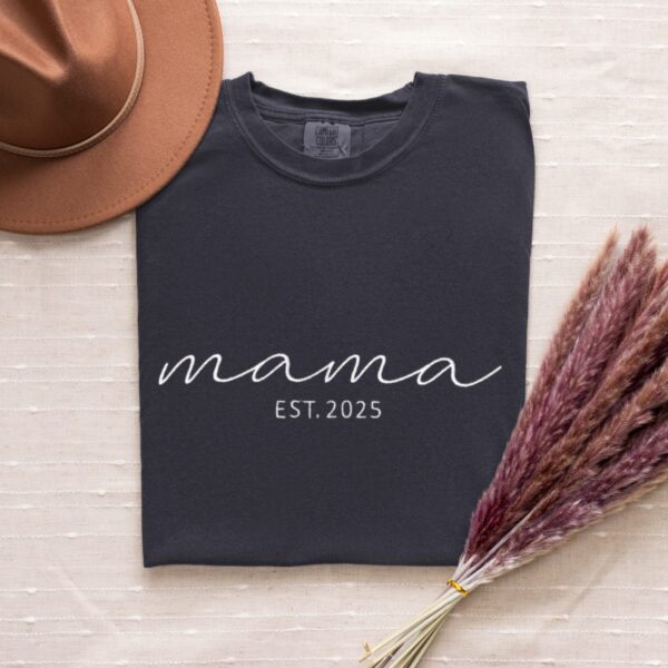 Graphite Comfort Colors Embroidered Mama T-Shirt folded with white 'mama EST. 2025' embroidery.