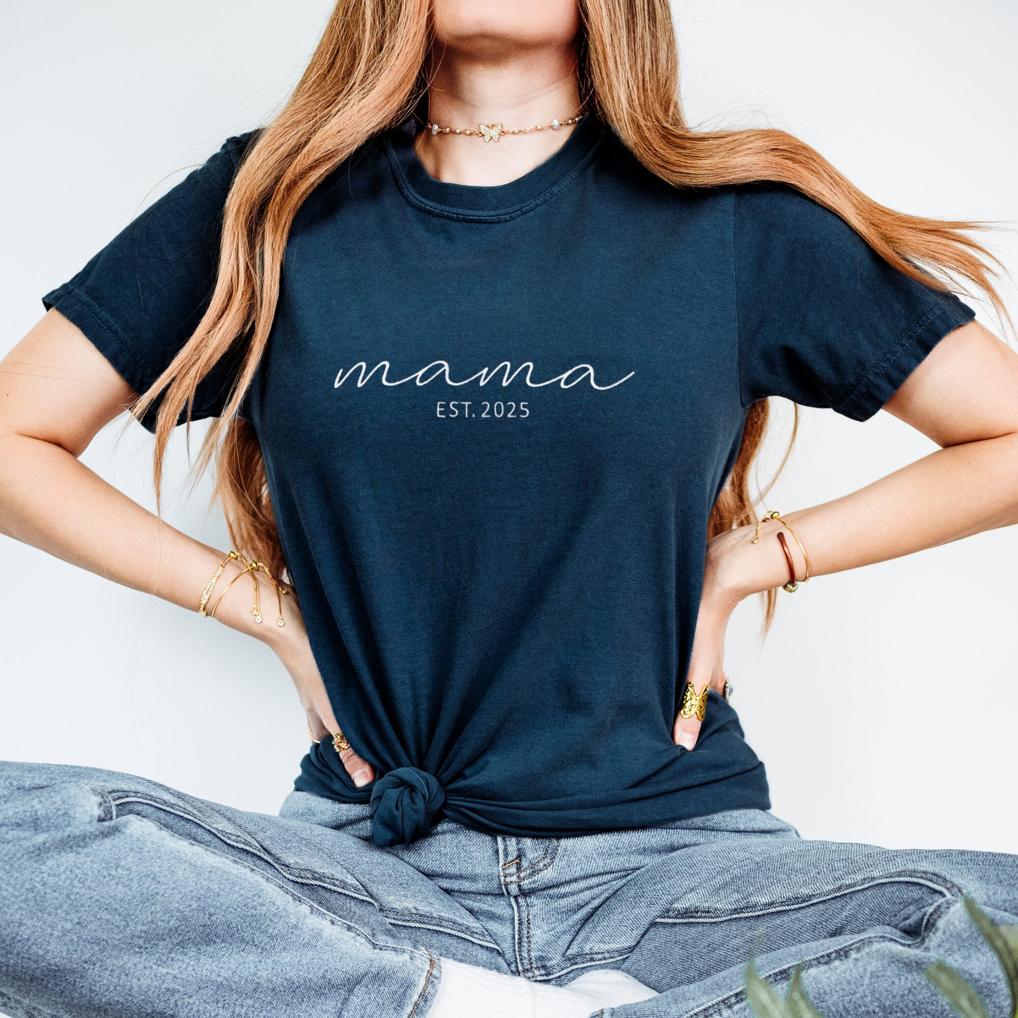 Comfort Colors Embroidered Mama T-Shirt in navy blue folded with white 'mama EST. 2025' embroidery.