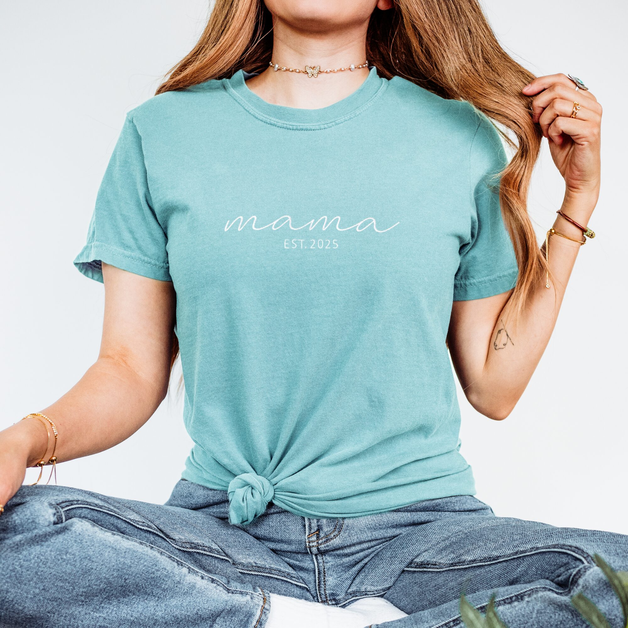 Seafoam Comfort Colors Embroidered Mama T-Shirt with white script 'mama EST. 2025', folded flat lay.