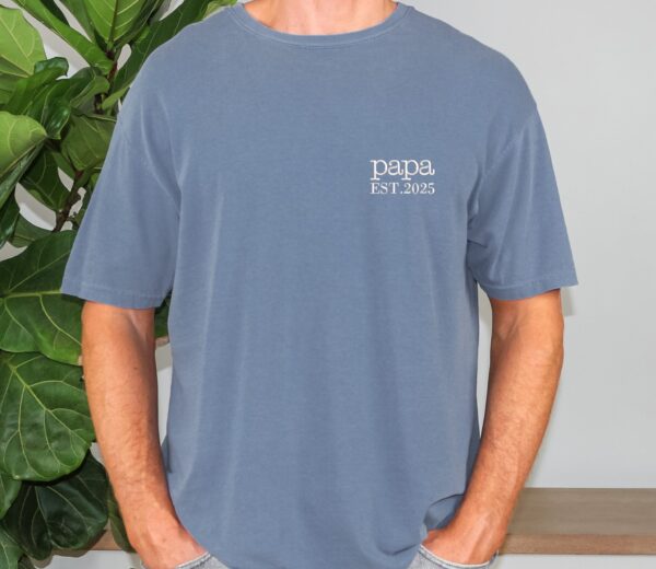 Blue Jean Comfort Colors Minimalist Papa Shirt worn by man, “papa EST. 2025” embroidery on chest.