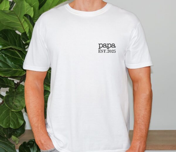 White Comfort Colors Minimalist Papa Shirt worn by man, black “papa EST. 2025” embroidery on chest.