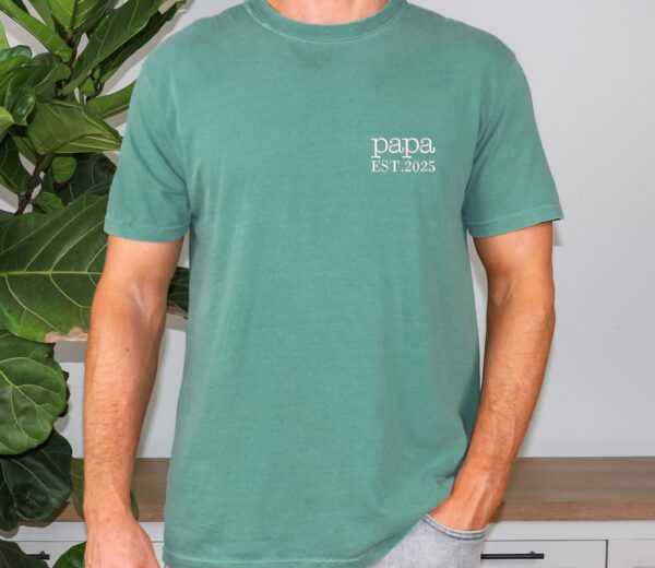 Seafoam green Comfort Colors Papa Shirt worn by man, white “papa EST. 2025” embroidery, casual fit.